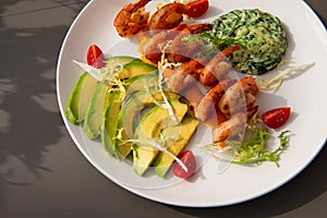 Healthy shrimp dish. Grilled shrimps and avocado.