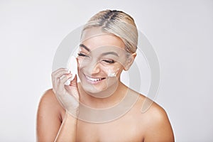 Healthy skin is already half of the victory. Studio shot of a beautiful young woman washing her face against a grey