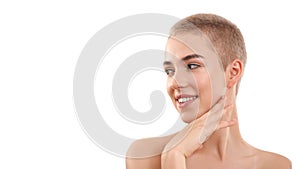 Healthy skin. Portrait of a beautiful smiling blond woman with short hair and nude make up touching her face with hand