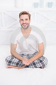 Healthy sleep concept. Tips promoting healthful sleep habits. Handsome man relaxing in bed. Establish regular nightly