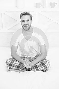 Healthy sleep concept. Tips promoting healthful sleep habits. Handsome man relaxing in bed. Establish regular nightly