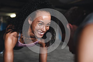 Healthy smiles go well with healthy bodies. a sporty young couple exercising together inside an underground parking lot.