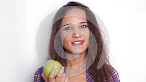 Healthy smiles young brunette woman eating green apple. Slow motion. 3840x2160