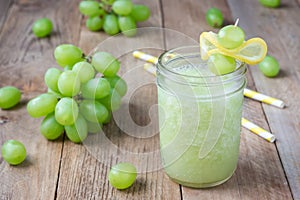 Healthy smoothie with green grape, lemon and honey in jar, horizontal