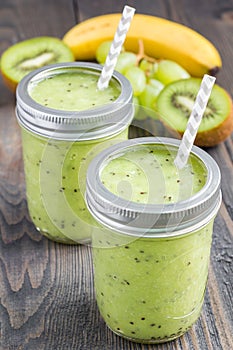 Healthy smoothie with kiwi, green grape, and banana in jars