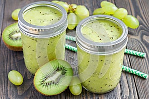 Healthy smoothie with kiwi, green grape, and banana in jars