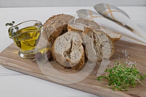 Healthy snack. Cereals bread, olive oil with herb spicy and garlic. Fresh cress salad.