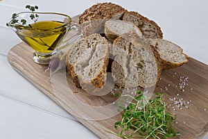 Healthy snack. Cereals bread, olive oil with herb spicy and garlic.Fresh cress salad.