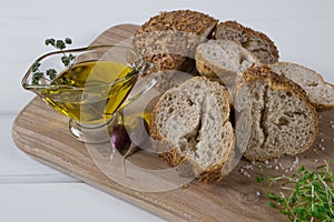 Healthy snack. Cereals bread, olive oil with herb spicy and garlic. Fresh cress salad.