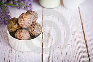 Healthy snack. Energy ball with date plam, black and white sesame, chia and rasin in ceramic bowl on wooden table. Vegan