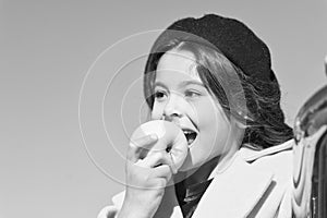 Healthy snack for a kid. Cute child eating healthy fruit on sunny day. Little girl biting into juicy green apple for