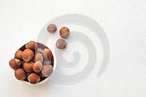 Healthy snack nuts. Top view of bowl with hazelnuts on table