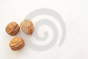 Healthy snack nuts.  Top view three walnuts on table