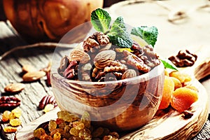 Healthy snack: raw nuts and dried fruit, decorated with mint. Vi photo