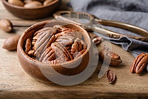 Healthy snack rich in vitamins and minerals, fresh shelled and in-shell pecans in a bowl