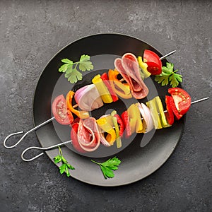 Healthy snack. Skewers with bell peppers, purple onions, tomatoes, sausage.