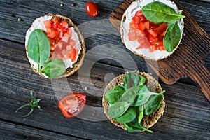 Healthy snack with spinach, tomato, ricotta and whole grain bread