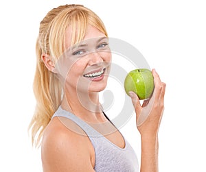 Healthy snacking for a healthy body. Studio portrait of an attractive young woman eating an apple isolated on white.