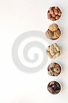 Healthy snacks nuts and dried fruits. Top view of bowls on table