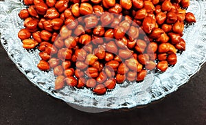 healthy soaked black grams in plate isolated on black background closeup image