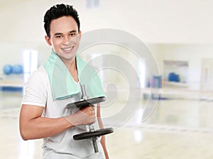 Healthy sports man with dumbel smiling photo
