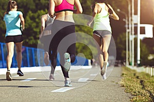 Healthy sports people trail running living an active life. Happy lifestyle athletes training cardio together in summer