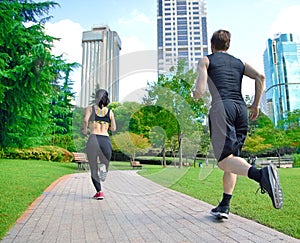 Healthy sports people trail running living an active life. Happy lifestyle couple of athletes training cardio together in summer