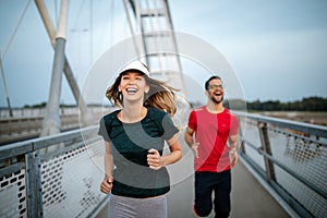 Healthy sporty young people jogging and running outdoors