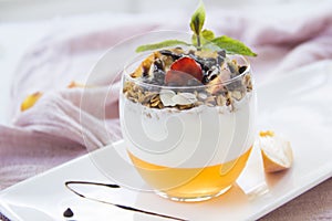 Healthy strawberry, peach and walnut parfait in a glass