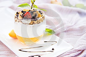 Healthy strawberry, peach and walnut parfait in a glass