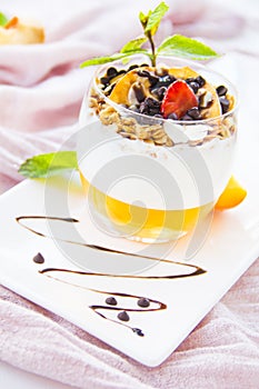 Healthy strawberry, peach and walnut parfait in a glass