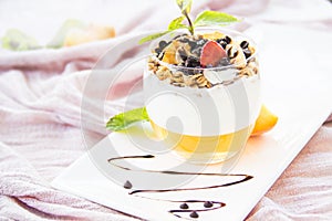 Healthy strawberry, peach and walnut parfait in a glass