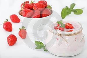 Healthy strawberry yoghurt in a glass jar