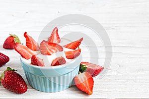 Healthy strawberry yogurt with fresh berries over white wooden table. healthy breakfast