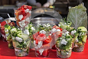 Healthy street food vegetables salad in plastic cups