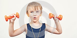 Healthy strong kid with dumbbell on white background. Smiling boy is doing sport exercises. Happy and healthy childhood. Funny