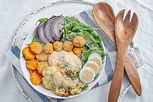 Healthy superbowl or Buddha bowl with salad, baked sweet potatoes