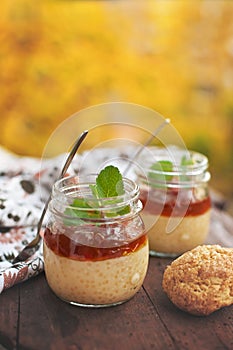 Healthy tapioca pearls pudding dessert with coconut milk and cherry jam.