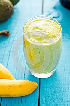 Healthy Tasty Green Avocado Shake or Smoothie, Made with Fresh Avocados, Banana, Milk on Blue Wooden Background, Raw Food