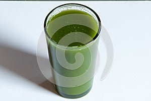 Healthy and tasty green juice on white background