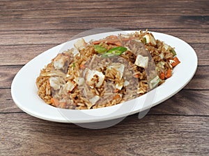 Healthy and tasty Paneer fried rice made of rice, mixed veggies and paneer, served in bowl over a rustic wooden background, Indo