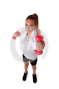 Healthy teen girl with dumbbells working out with towel on shoulder. Isolated on white background. fitness gym concept.