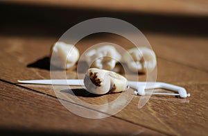 Healthy teeth and cavity tooth on brown background