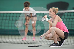 Healthy tennis player thirsty drinking water