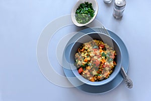 Healthy vegan bowl with quinoa, pumpkin, pepper and carrot on gray wooden background. Selective focus