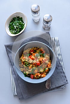 Healthy vegan bowl with quinoa, pumpkin, pepper and carrot on gray wooden background. Selective focus