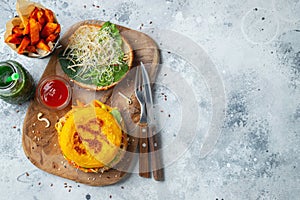 Healthy vegan burger with fresh vegetables and white sauce. Top view with copy space. Flat lay