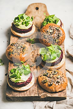 Healthy vegan burgers with beetroot patties and green sprouts