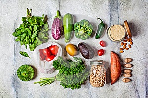 Healthy vegan food flat lay. Fresh vegetables, fruits, nuts, quinoa, chickpeas on white background. Zero waste, vegan food, eco