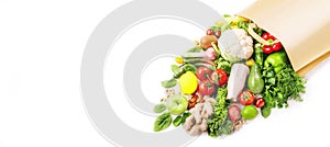Healthy vegan food in full paper bag, vegetables and fruits on white background, copy space, banner. Shopping food, supermarket,